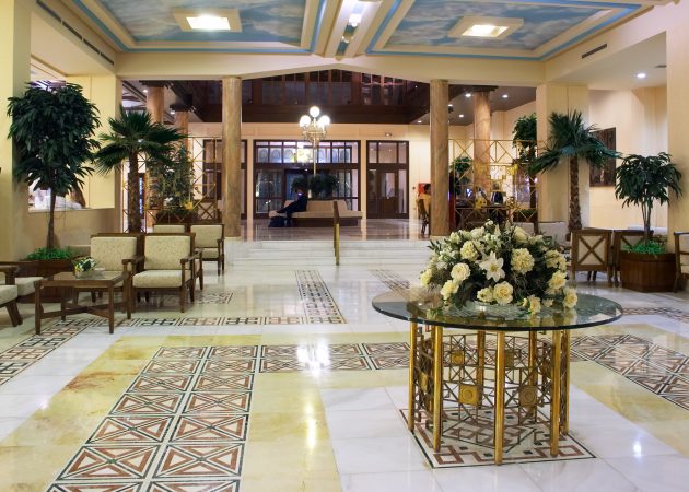 Hall,In,Hotel,With,Marble,Floor,And,Flowers,On,The